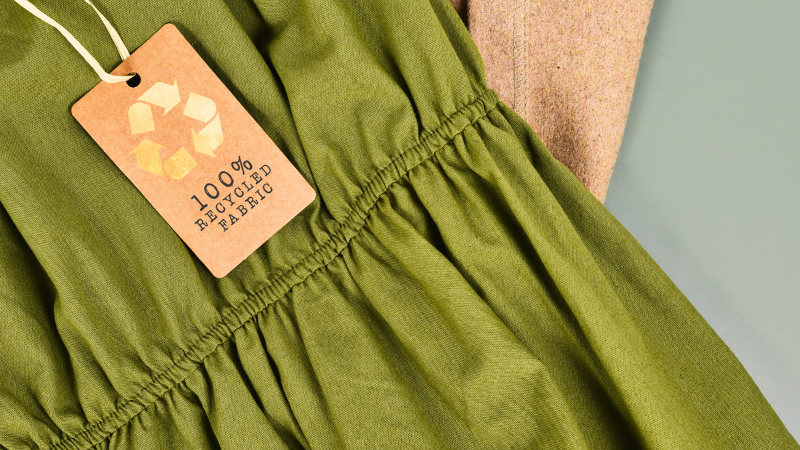 A green dress with a recycle certification label on it