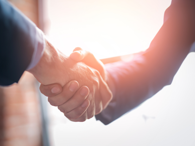 Image of two people shaking hands.