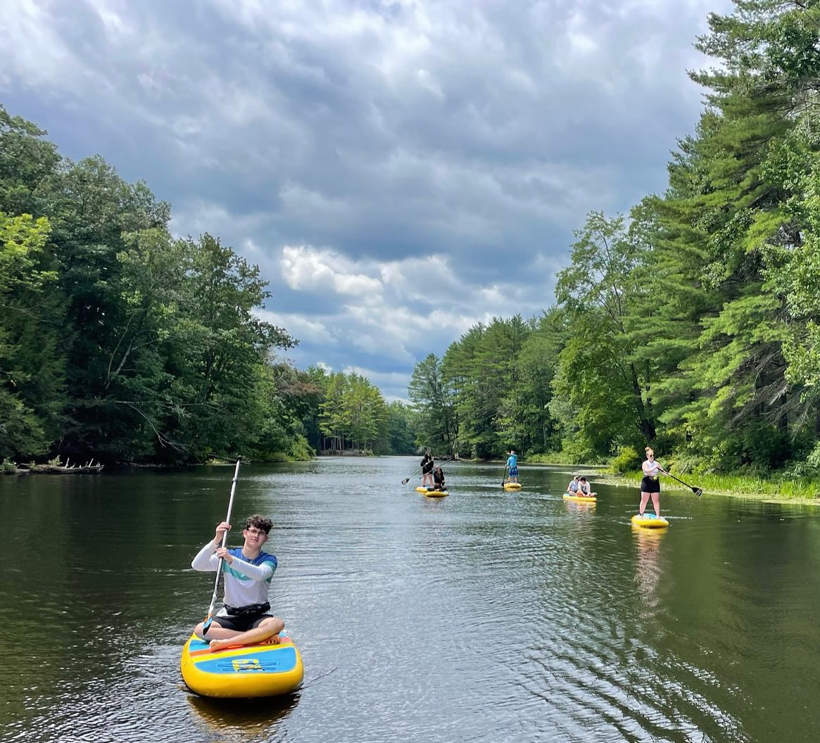 man sitting on an inflatable paddle board