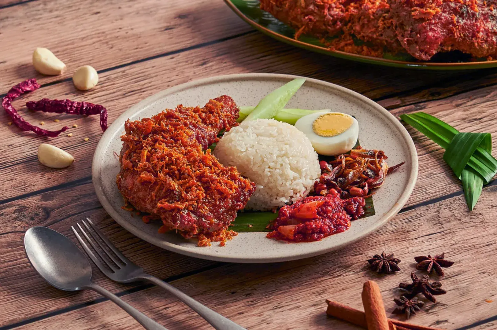 Nasi Lemak served on a plate, showcasing rice, eggs, and meat, from the Old Airport Road Food Centre in Singapore. Photo by Google.