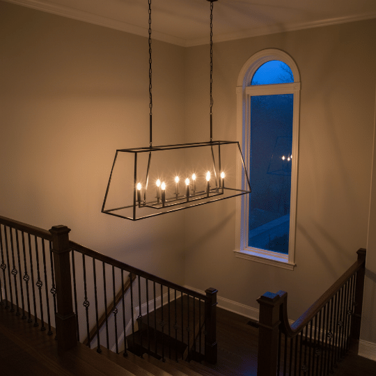 Black rectangular lantern chandelier suspended by chains, a smart option for high ceiling chandelier ideas.