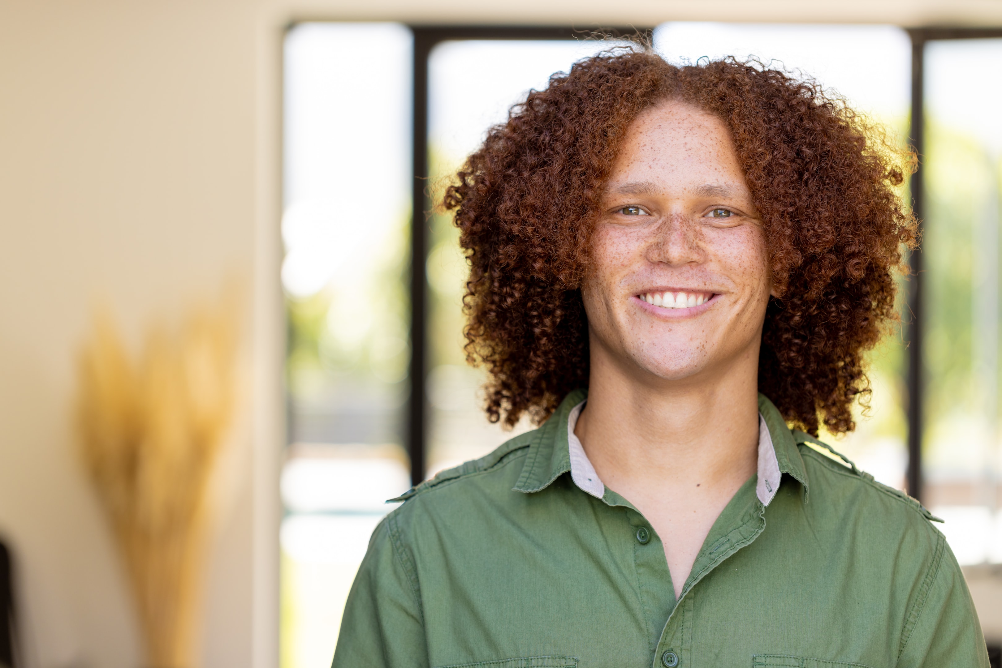 a smiling person who went through tooth extraction cost with their oral surgeon