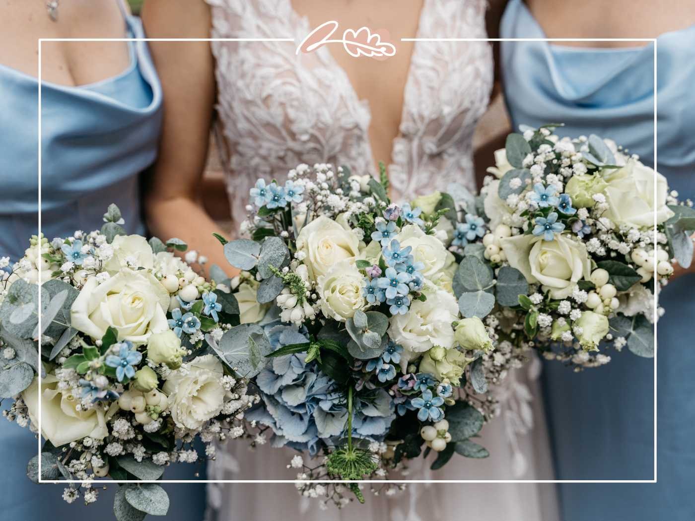 Bridesmaids standing close to the bride, each holding a bouquet of white and blue flowers, adding elegance to the wedding. Fabulous Flowers and Gifts.