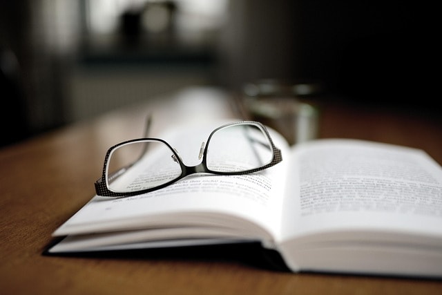 A book and glasses, representing the book market.