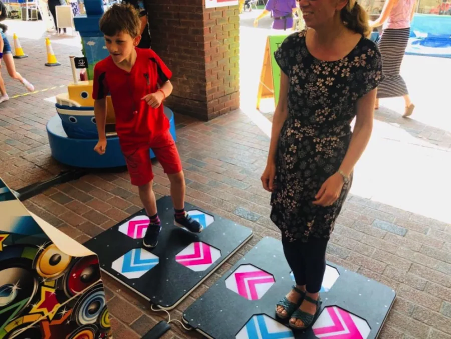 A person dancing on a dance machine in a corporate event