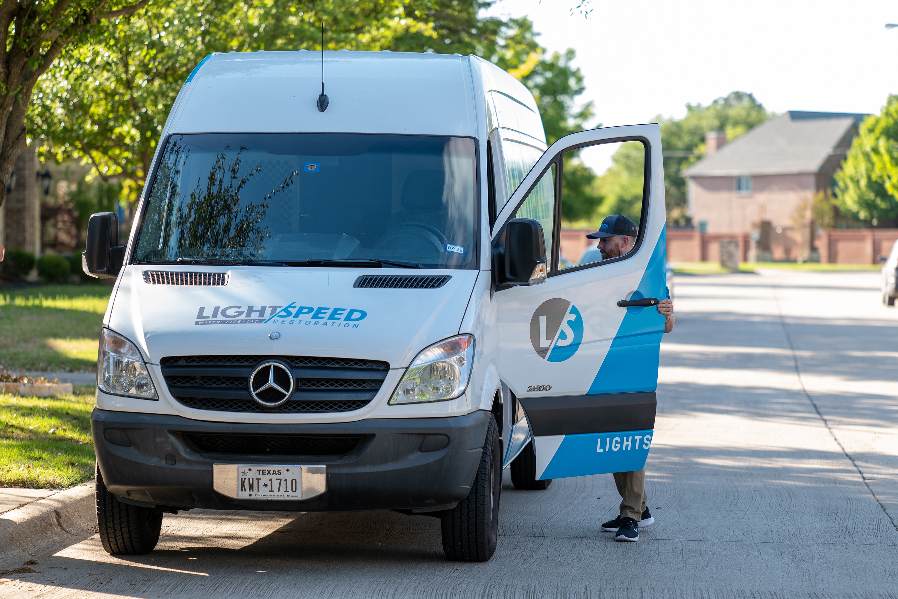 A professional restoration team arrives at a residential home equipped with personal protective equipment and tools to address a mold problem. They are prepared to conduct mold remediation to prevent mold growth and improve indoor air quality, as visible mold growth and excess moisture have been identified in the house.