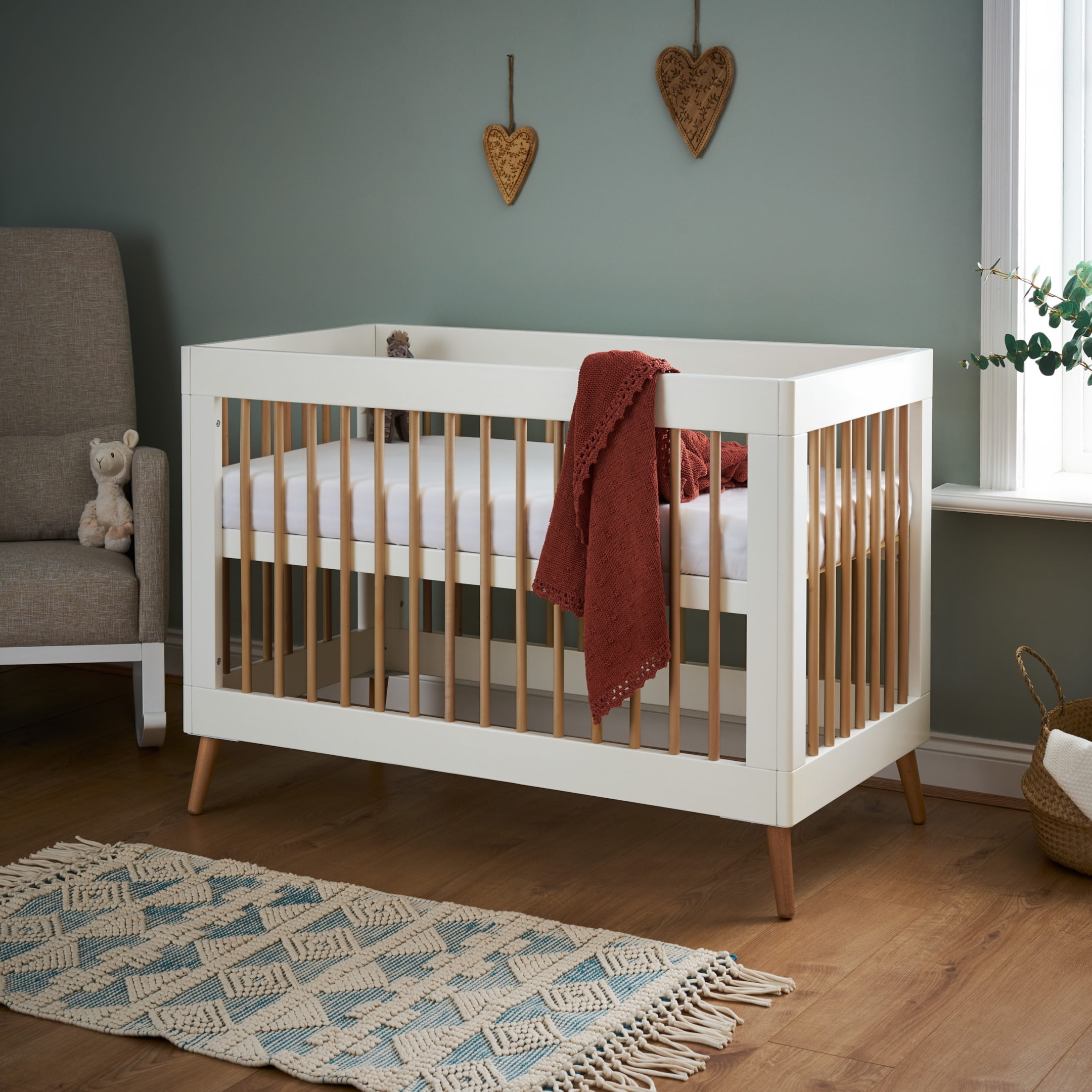A white mini cot bed