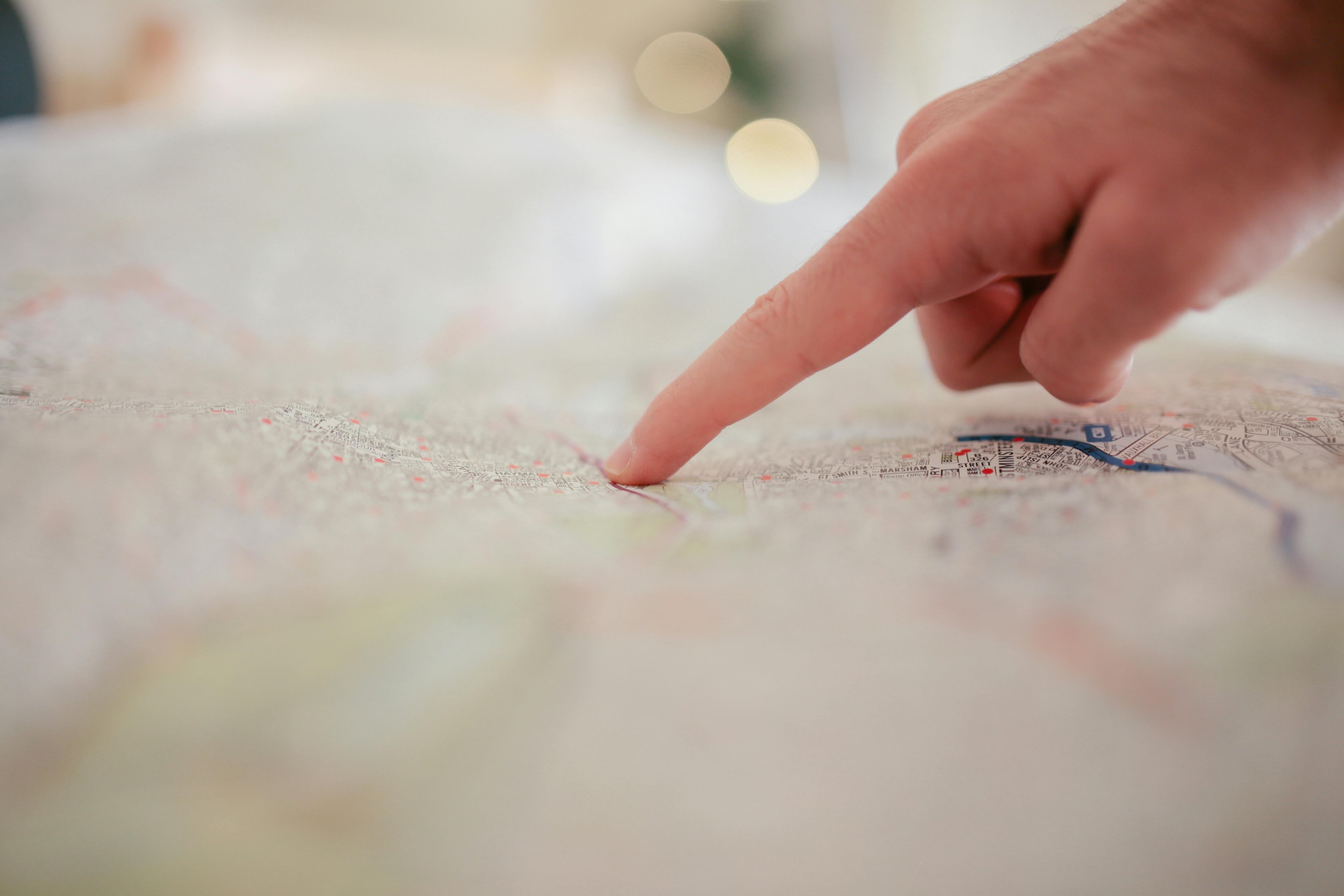 Pointing at map to find best place to purchase real estate.