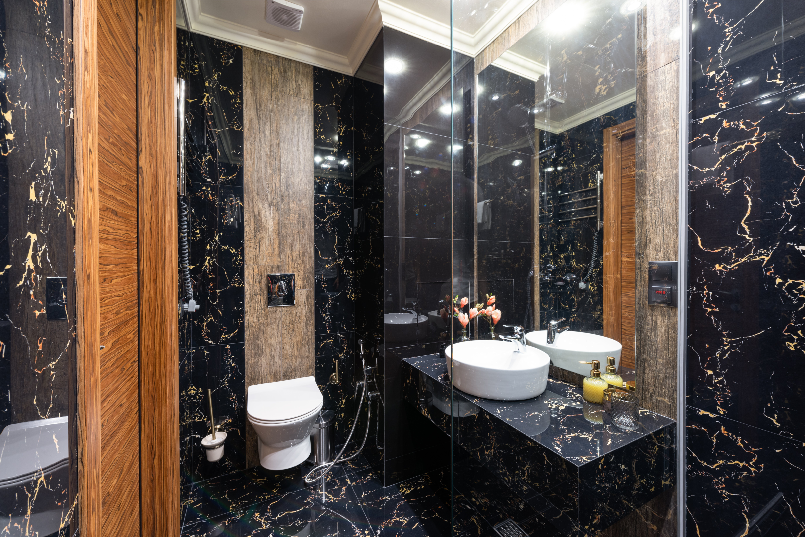 Dark marble tiles add a touch of luxury and opulence to larger spaces.