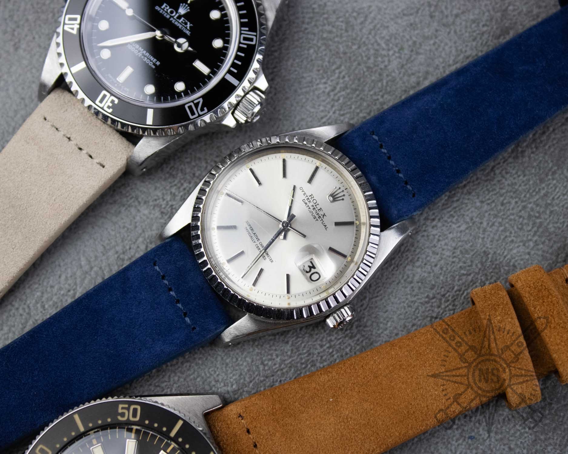 A close-up view of blue suede texture showcases its characteristic soft nap and rich color depth, highlighting the luxurious feel and quality of the material. This high-quality suede could be used for crafting elegant suede watch straps, adding a stylish touch to any timepiece.