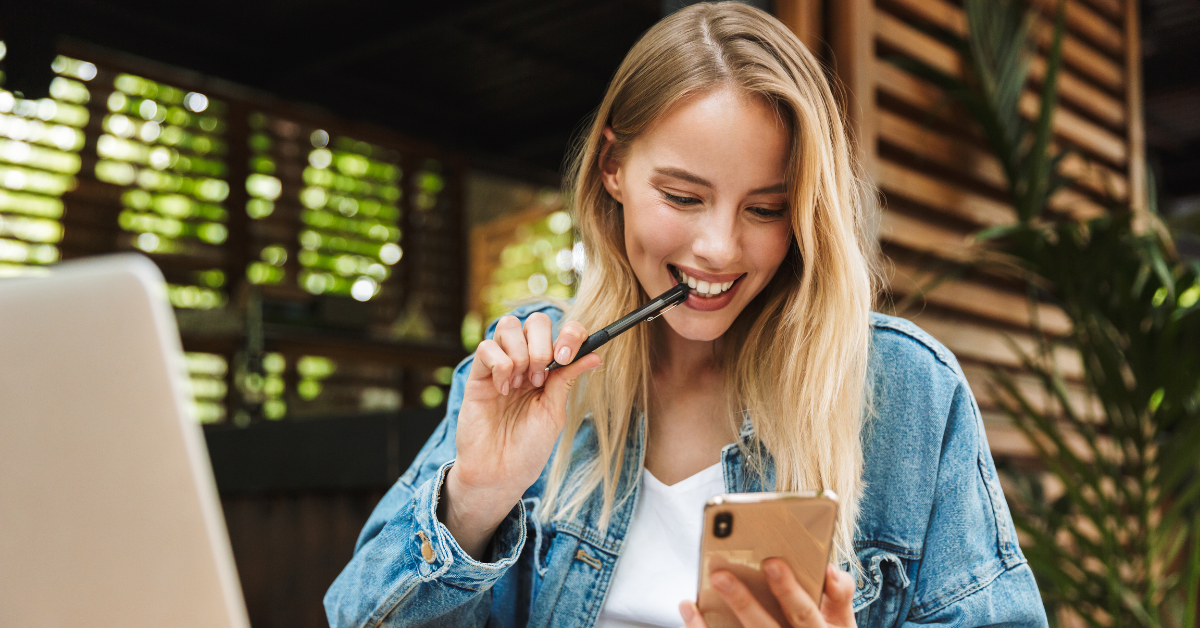 Woman biting a pen thinking does onlyfans report to irs