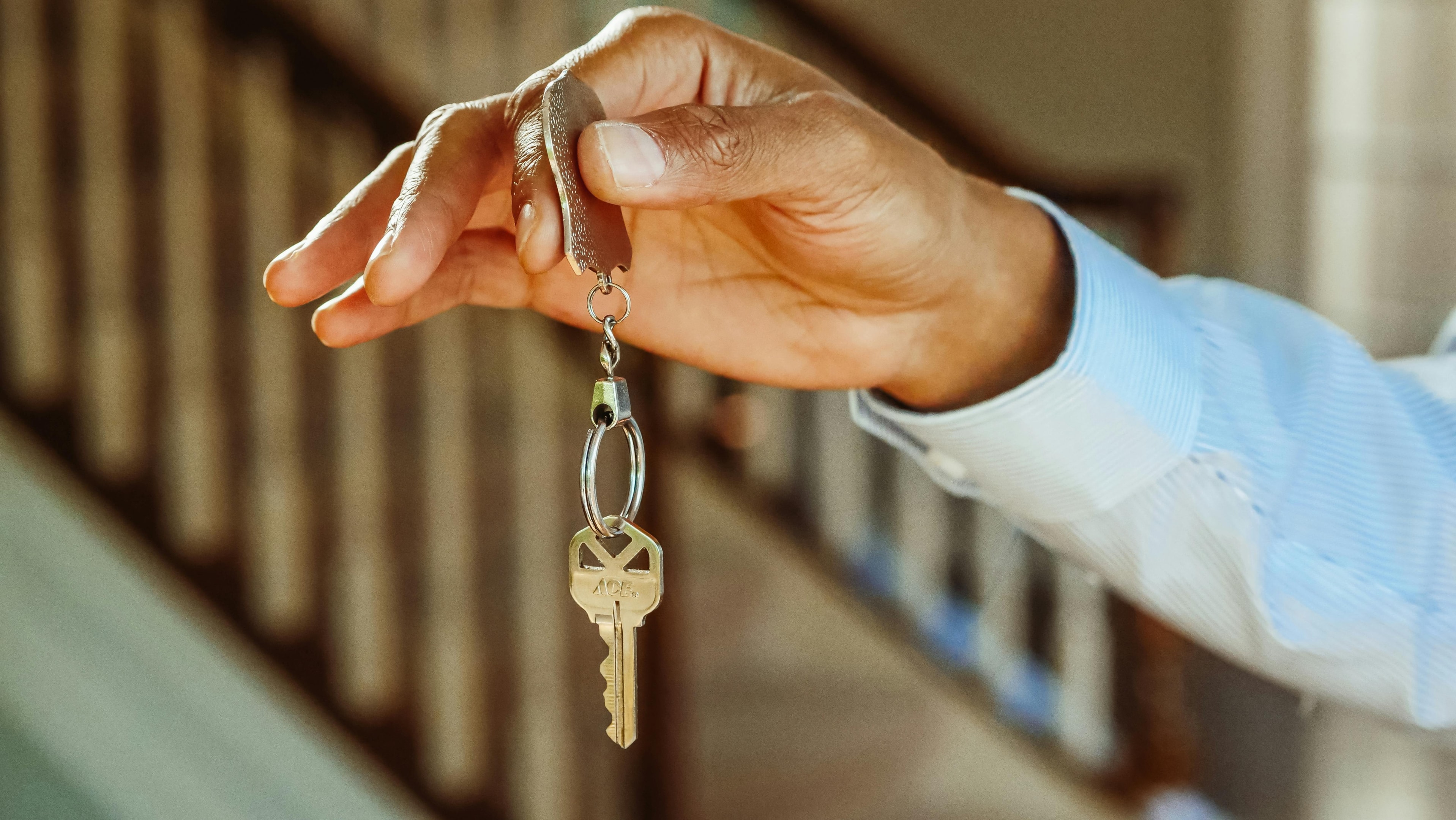 House key being held by real estate investor. 