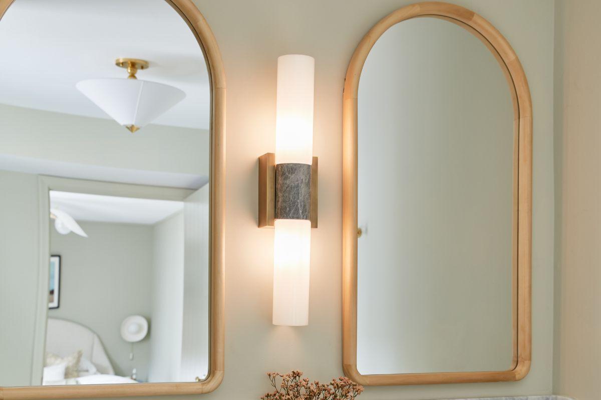 Bathroom wall light fixture ideas with a modern wall mounted light between two mirrors in a neutral, verified design style