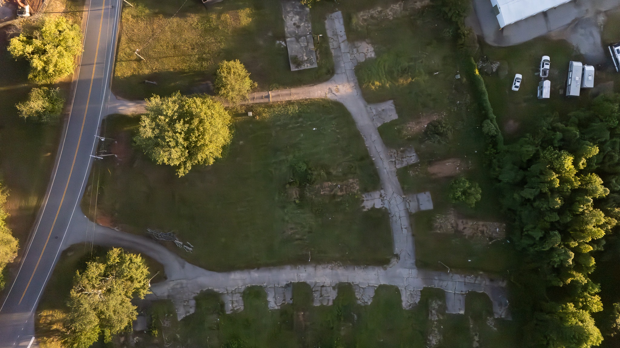 Aerial view of site preparation for a multifamily construction project, showing cleared land, excavation work, and utility vehicles on site.