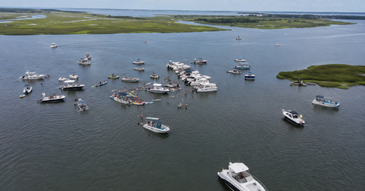 Boats moored in Manahawkin Bay near Ship Bottom NJ during a summer fishing gathering, showcasing calm bay waters perfect for boating and fishing vacations.