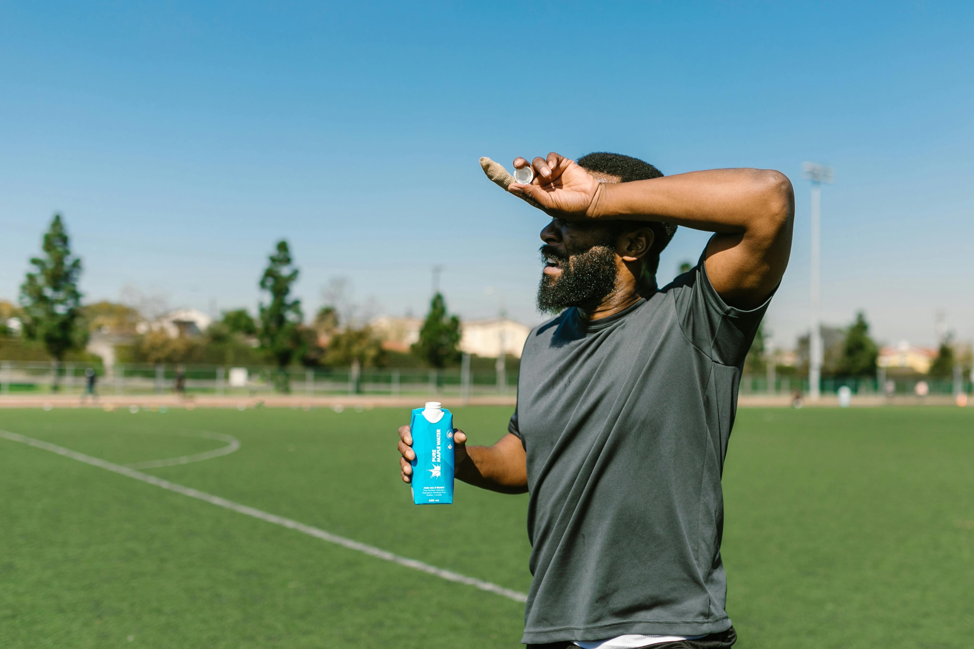 Photo by RDNE Stock project: https://www.pexels.com/photo/man-in-gray-t-shirt-holding-blue-bottle-of-water-and-touching-forehead-7187842/