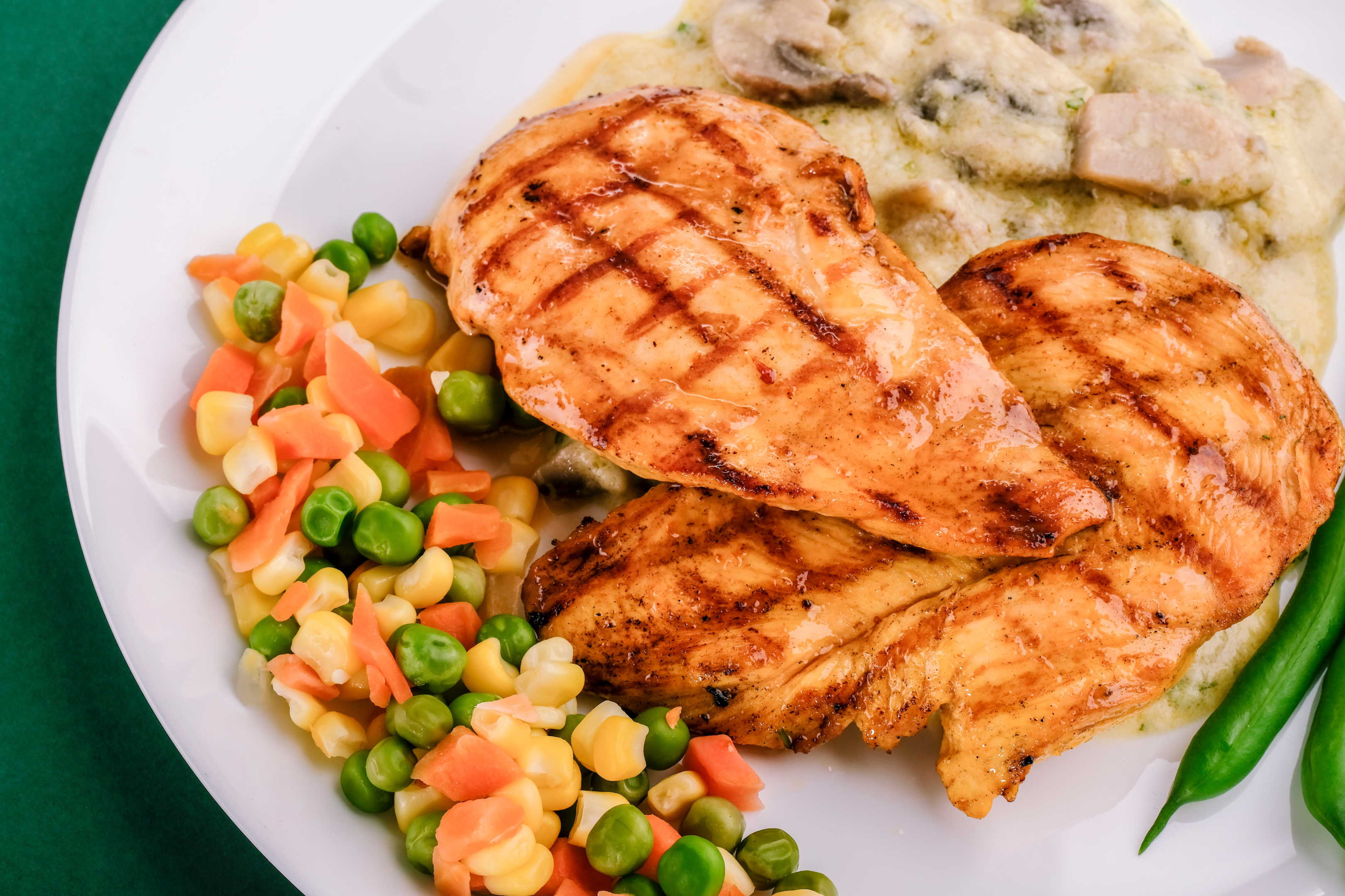 grilled chicken and vegetables on white ceramic plate