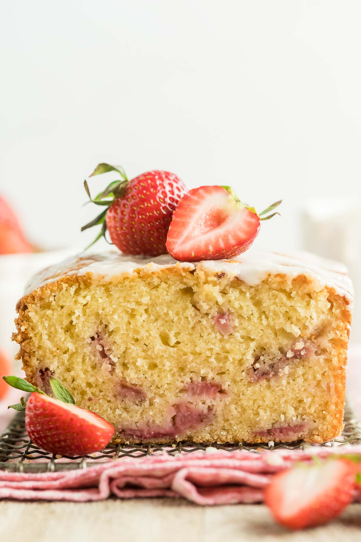 strawberry bread cut in half and topped with fresh strawberries
