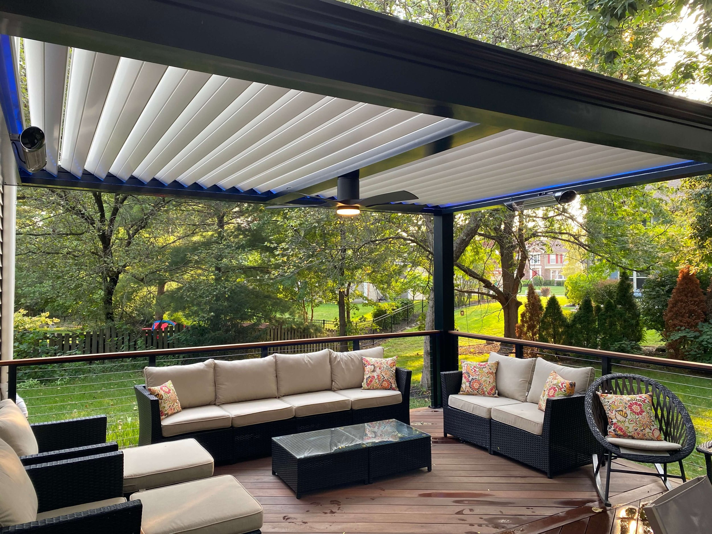 backyard pergola with lounging area create great space with plants and lawn with grass behind house