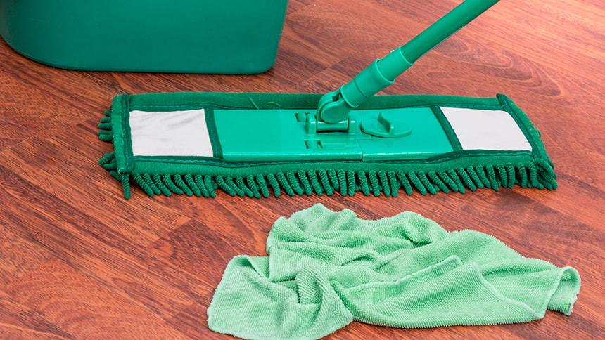 Green Chenille dry mop on hardwood floor
