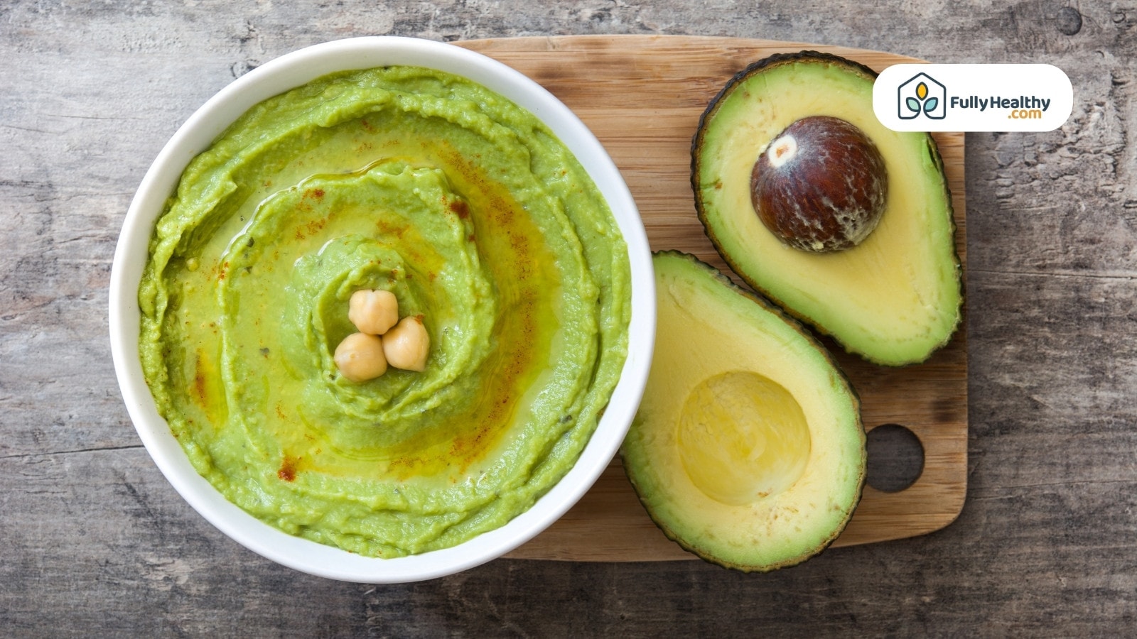 Bowl of avocado hummus with olive oil and chickpeas garnish