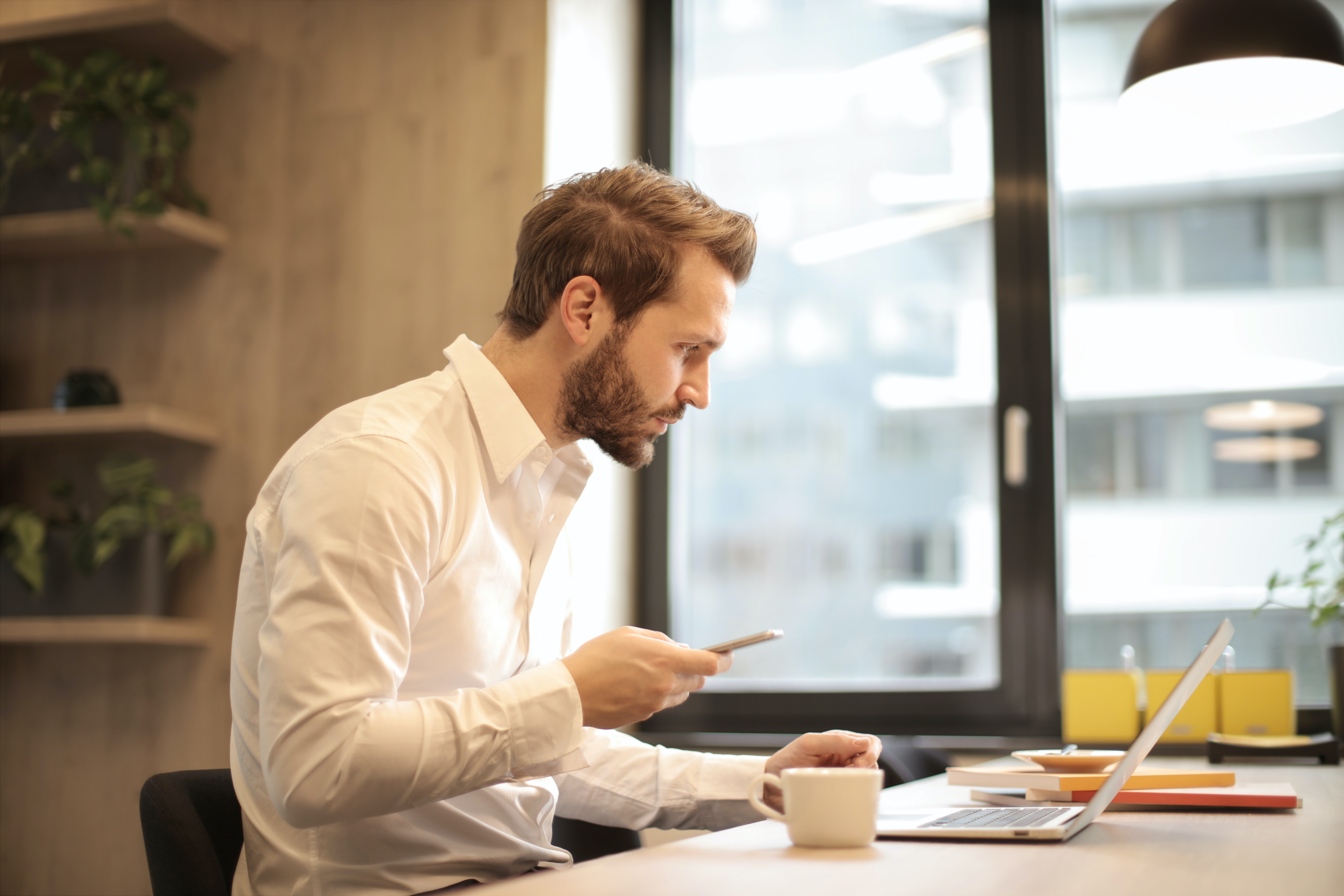 Man with phone and laptop