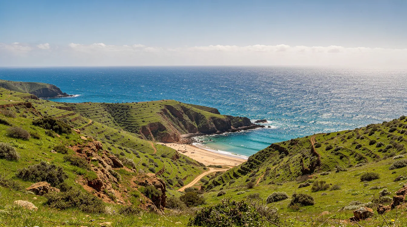 A coastal landscape in northern Morocco with a blue sea and green hills.