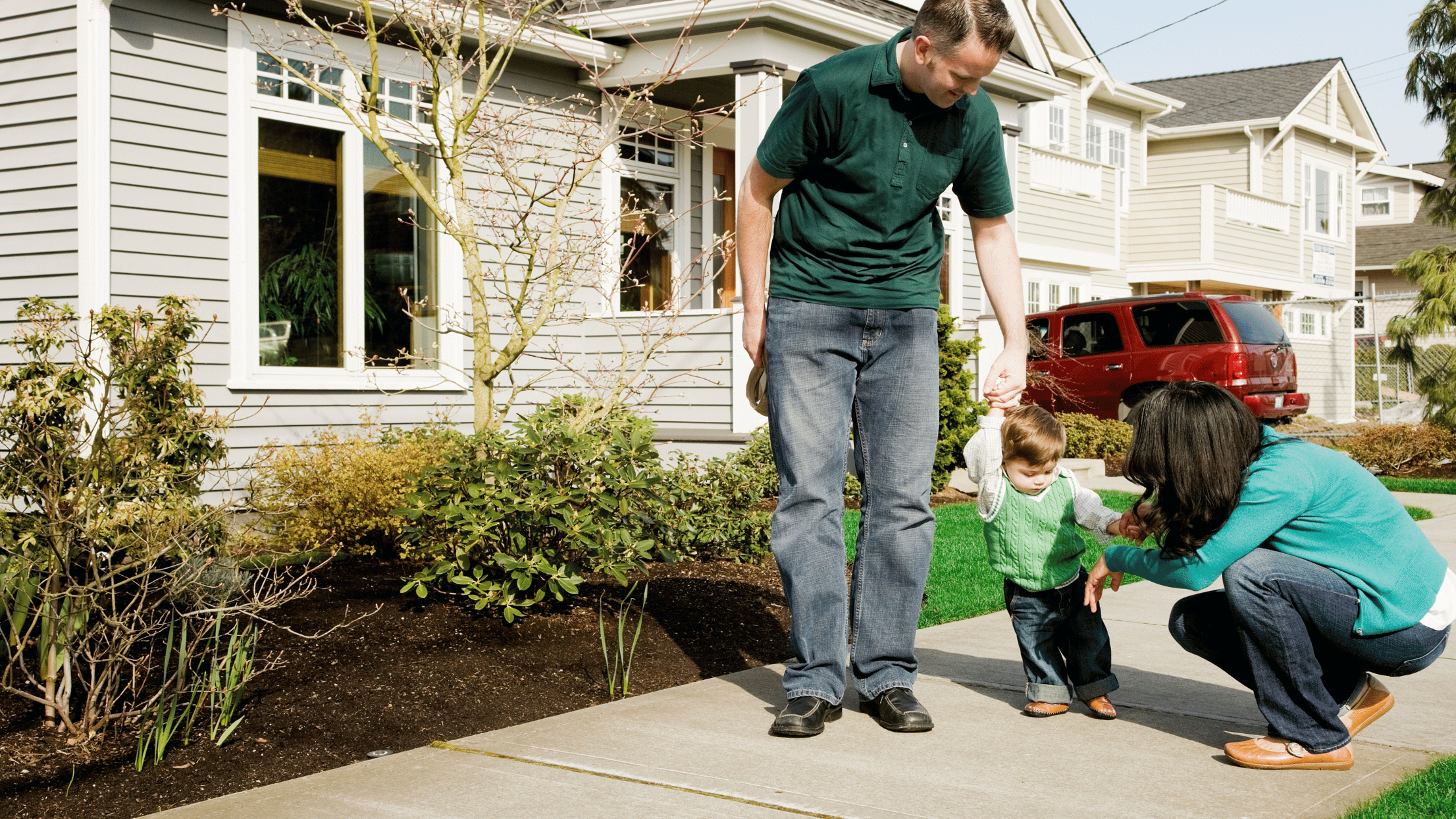 Happy family in front of a rental property in a residential neighborhood