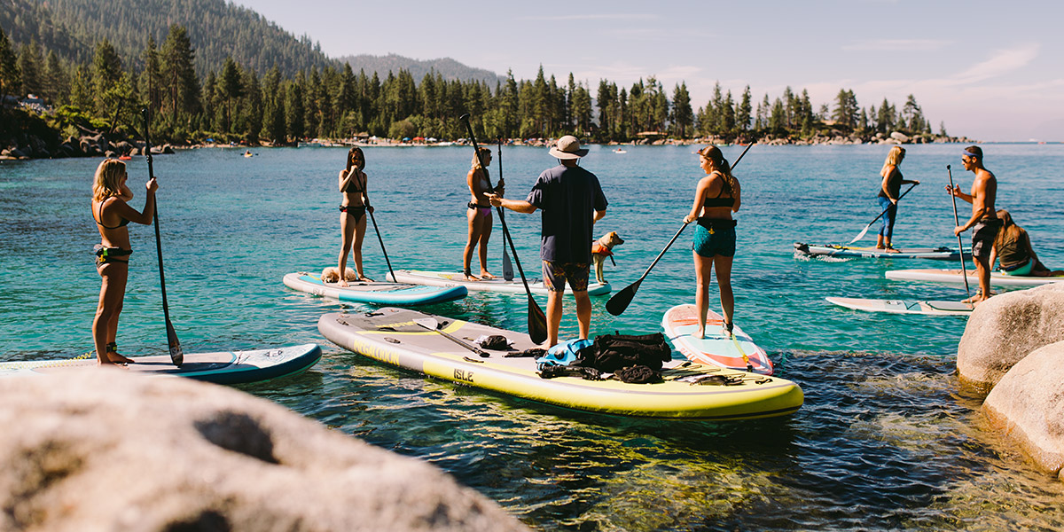 A group of people Paddle boarding