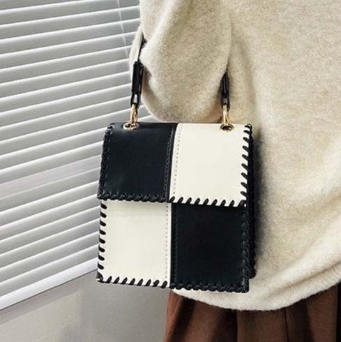 hand-made a purse with white and black squares with leather thread stitched 