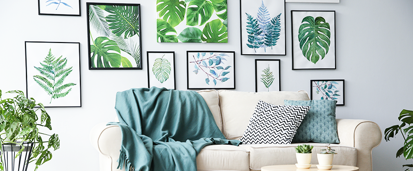 This gallery wall uses pictures of green plants to highlight the room's accent colour.