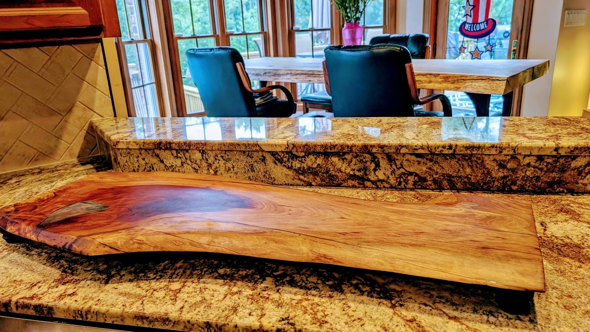 A wooden slab charcuterie board, which is an easy woodworking project that sells quickly at craft markets.