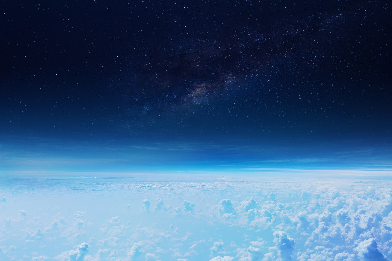 The Earth's mesosphere with few clouds and a dark space above.