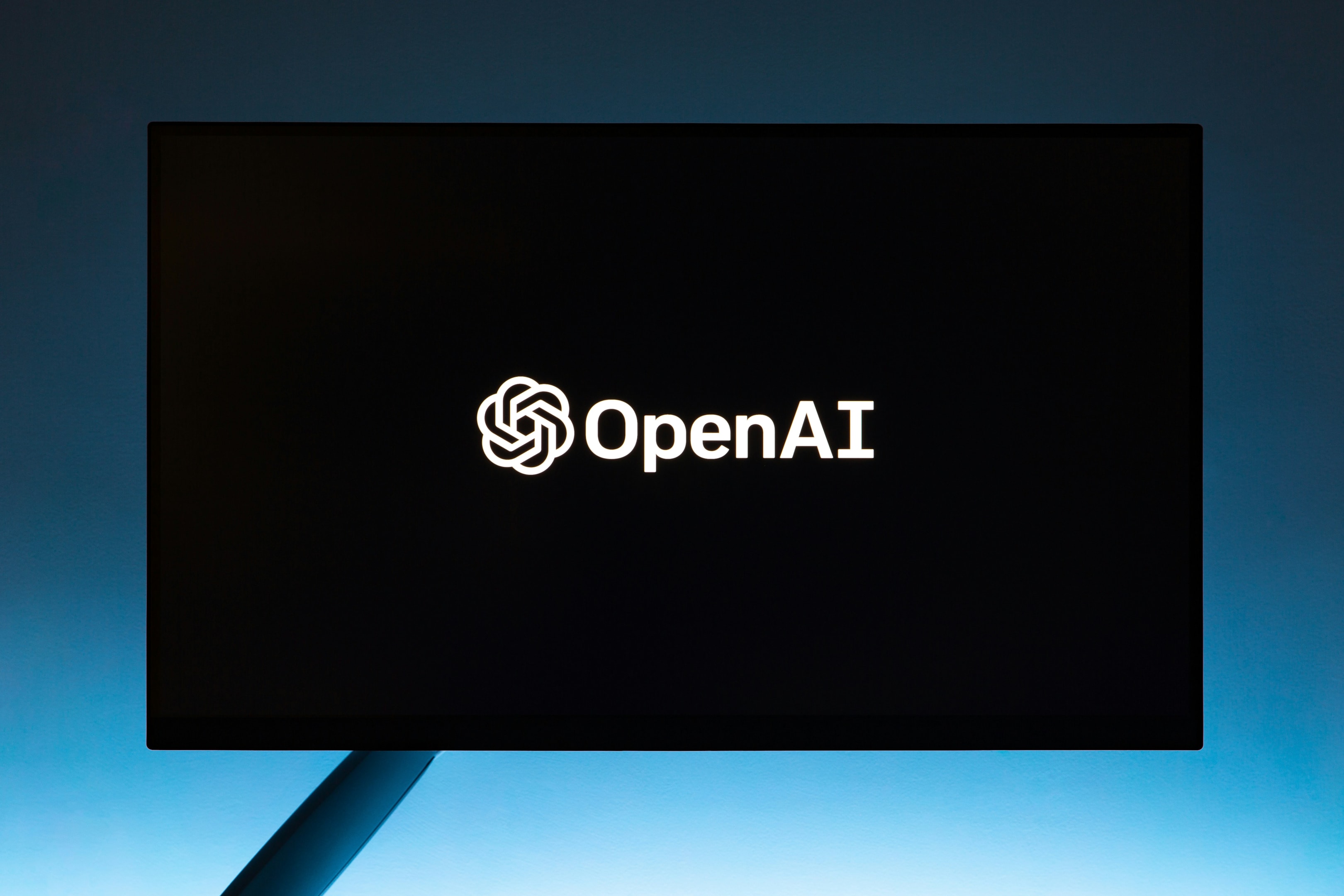 OpenAI logo on black and blue background