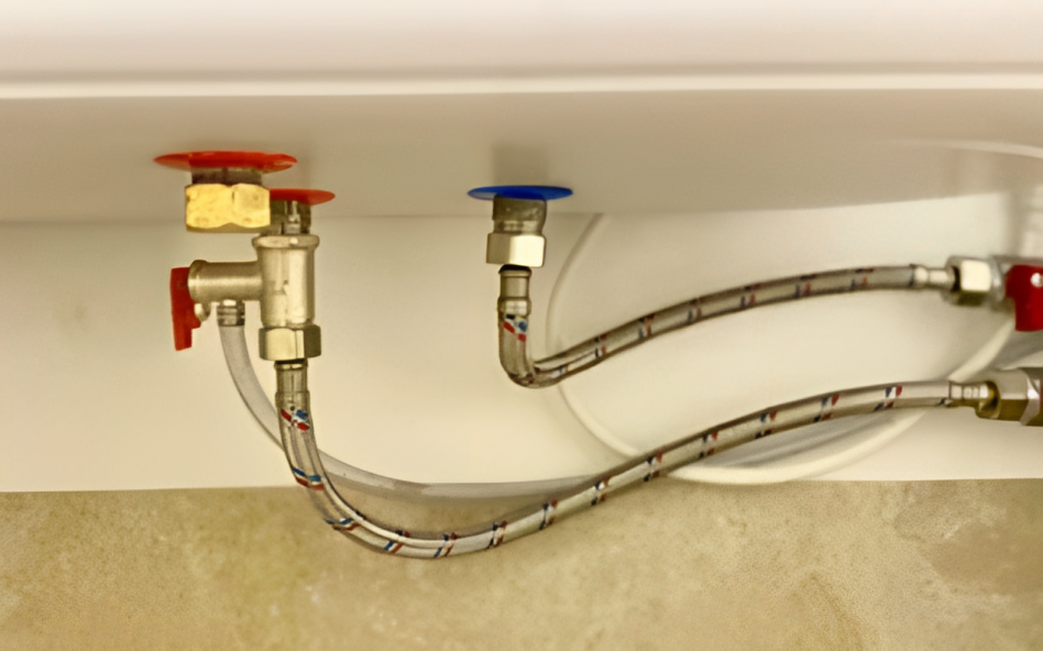 Water heater pressure relief valve in a bathroom.