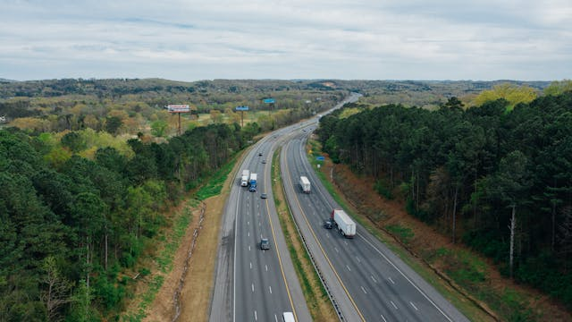 Fleet of trucks driving along a highway