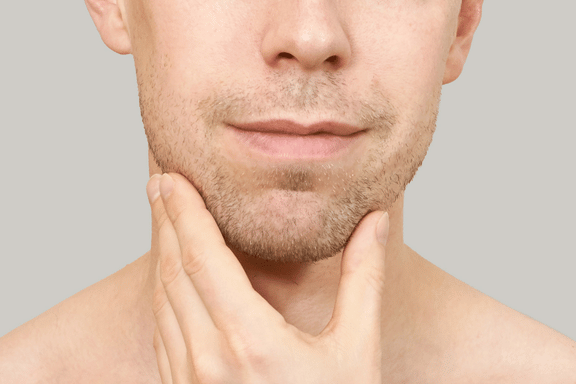 man holding jaw ready for corrective surgery