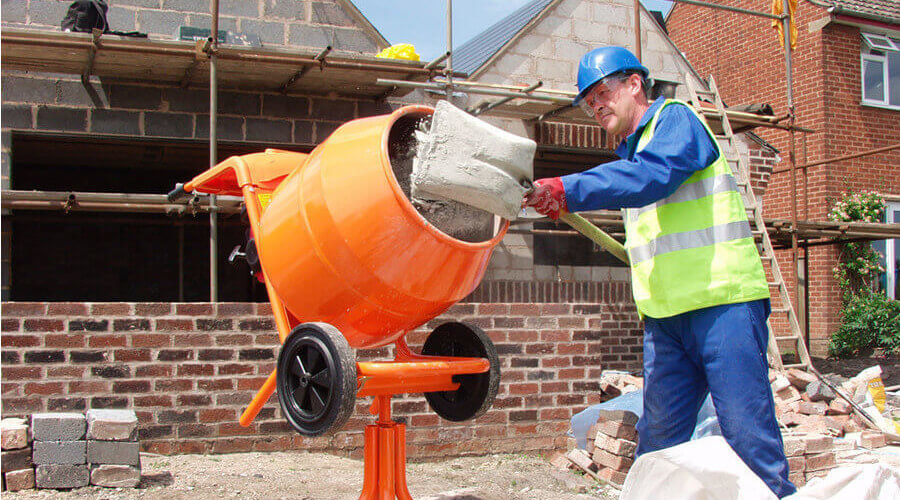 A person using a mixer with tools and attachments
