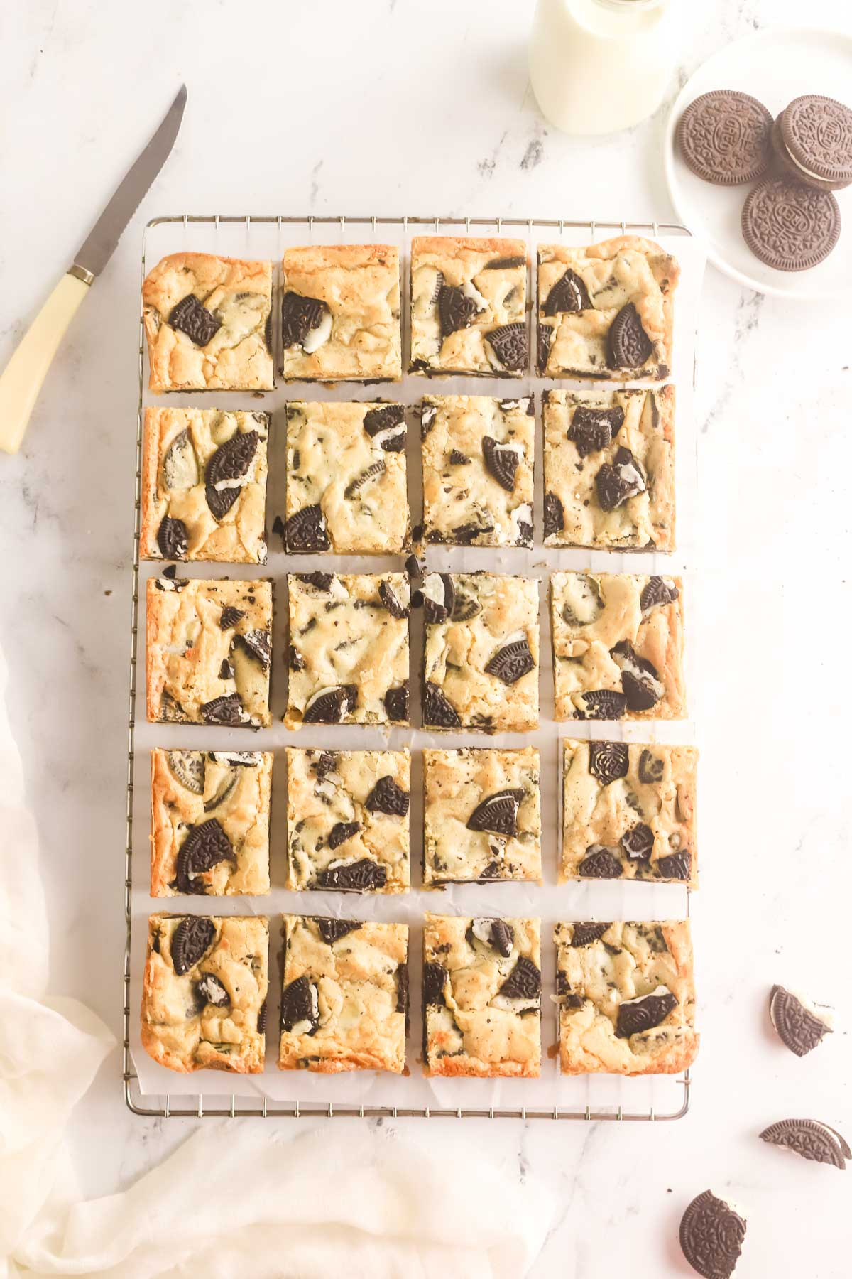 Oreo blondies cut into squares on a wire rack