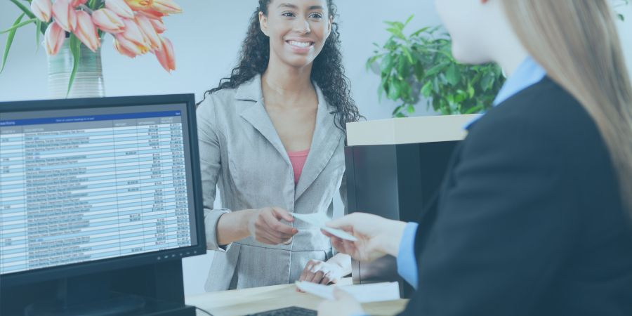 Woman serving another woman in a bank