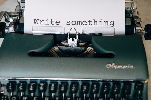 A typewriter with the phrase 'write something'.