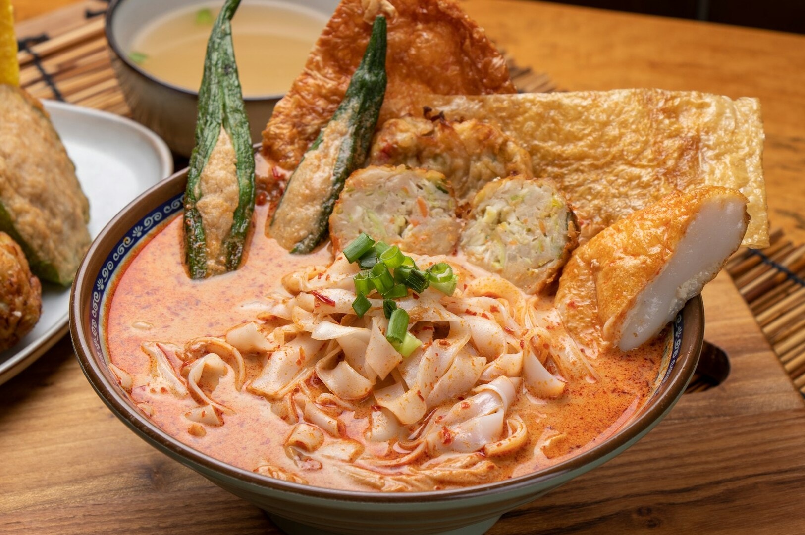 A bowl of Singaporean noodle soup, featuring various ingredients, showcasing a popular viral dish.