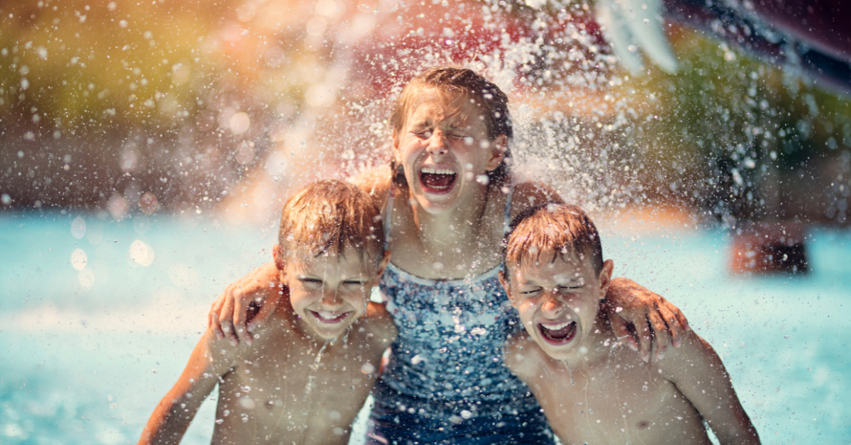 Children laughing and splashing together at a waterpark near North Wildwood, New Jersey, enjoying an action-filled day during their beach vacation.