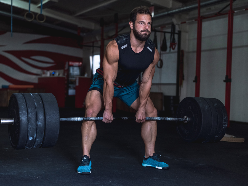 An image showing a person lifting weights in a gym.