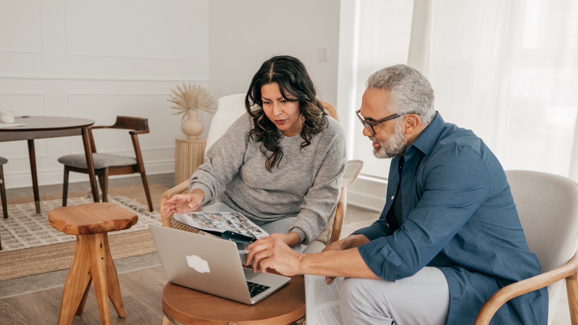 Dual Occupancy Homes - Two persons talking with each other and watching something on a laptop screen