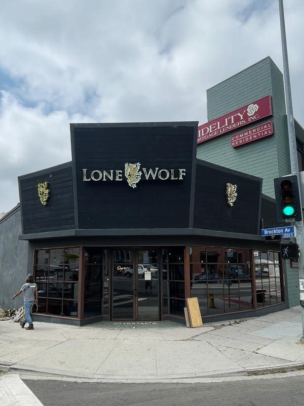 Open face channel letters illuminated with neon for Lone Wolf Cigars on Wilshire Blvd. in Los Angeles.