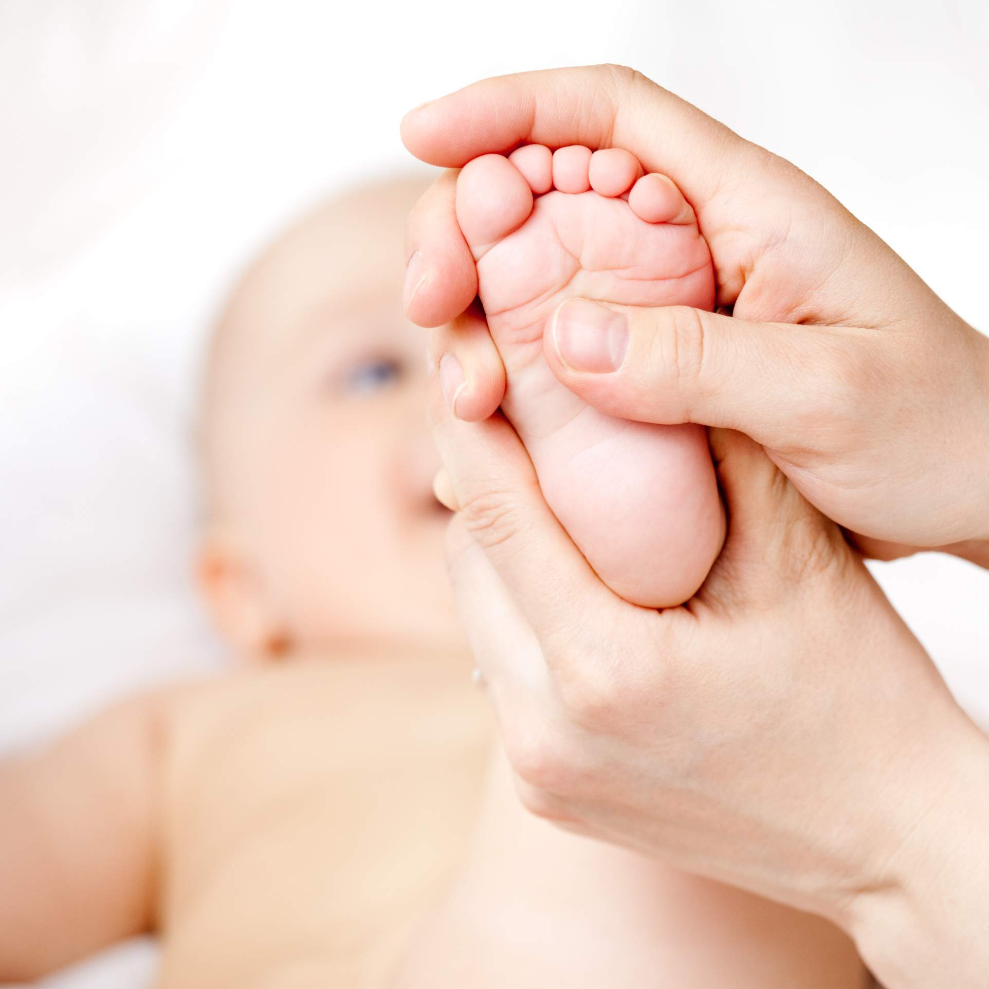 baby massage, baby's feet, foot reflexology, gently press