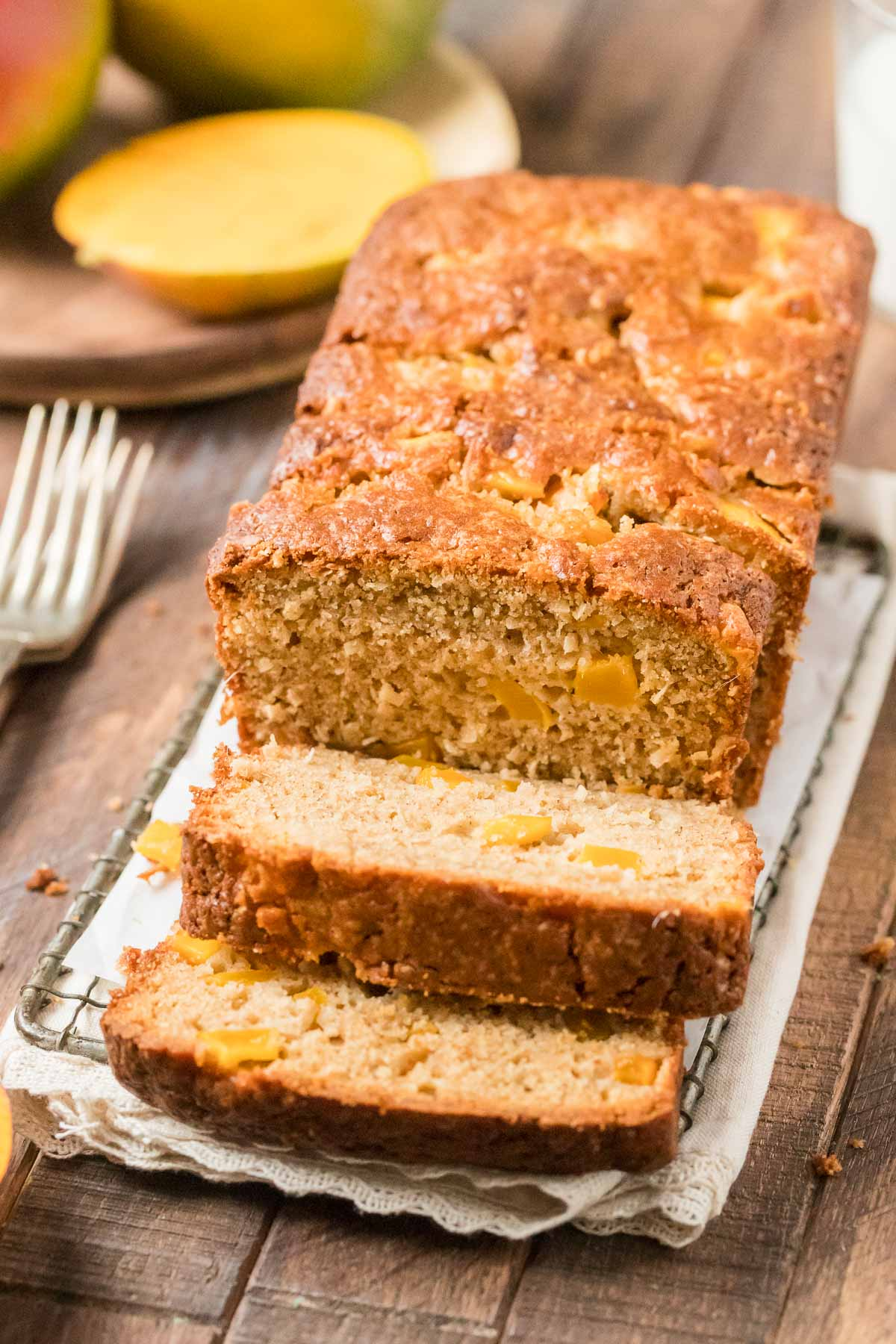 mango quick bread sliced on a wire rack