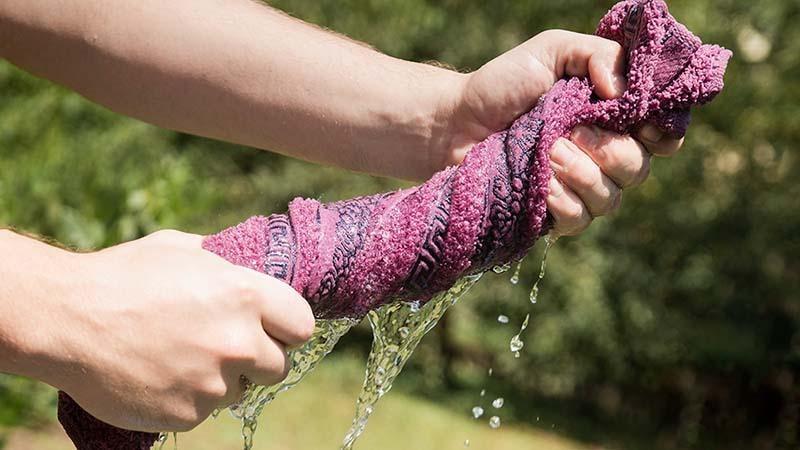Man Squeezing Water out of a Towel
