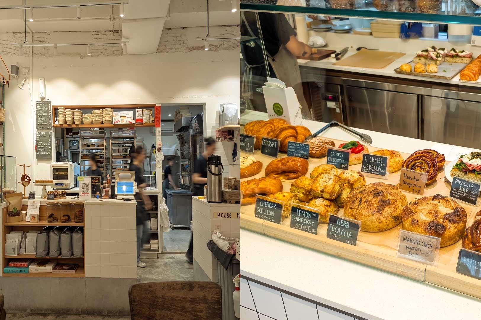 Left: Interior view of a modern bakery service counter with white-tiled counters, coffee bags and cookbooks on lower shelves, a digital POS screen, and an open doorway leading to a brightly lit kitchen with staff working in the background. Right: A close-up display case filled with fresh artisanal baked goods on wooden boards, including croissants, cheddar scallion scones, herb focaccia, and sourdough loaves, each labeled with small handwritten chalkboard signs.